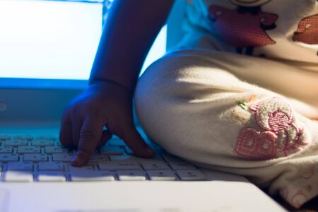 baby kid toddler playing computer at homeの写真素材