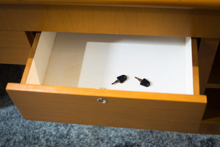 two black key in wooden drawerの写真素材