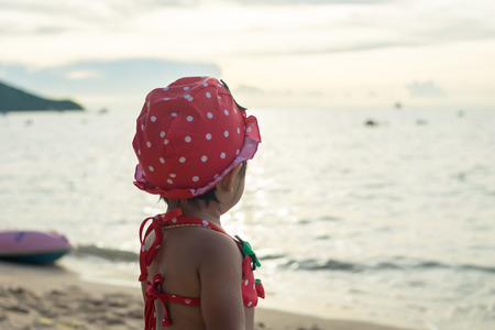 back view little girl on the beachの写真素材