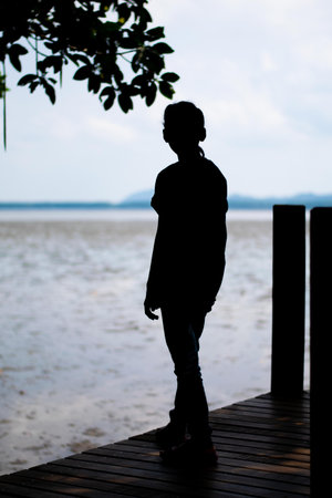 silhouette of baby girl standing on the beach