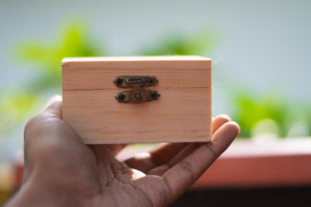 Wooden treasure box on hand