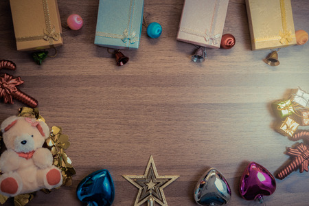 Christmas wooden background with decorations gift boxes on wooden boardの写真素材