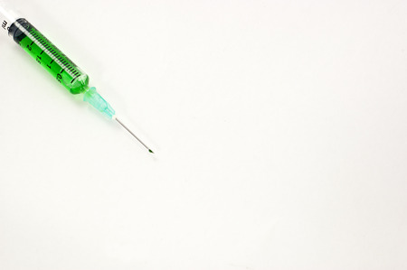 Green syringe with medicine inside.の写真素材