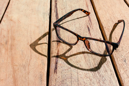 glasses on wooden table in the morning.の写真素材