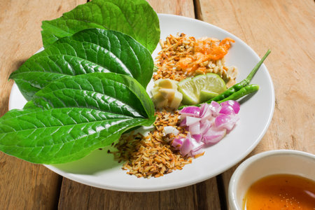 Savoury Leaf Wraps set on a wooden table.の写真素材