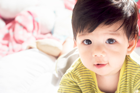 Asian boy on the couch while awakening.の写真素材