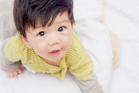 Asian boy on the couch while awakening.の写真素材