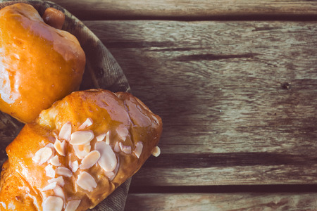 Sausage roll and Bread on wooden table with vintage tone picture.の写真素材