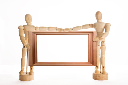 Wooden Mannequin Concept in Pose with Wood Frame on isolate white background.の写真素材