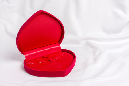 Red Heart Jewel case box on white fabric with space for text.の写真素材