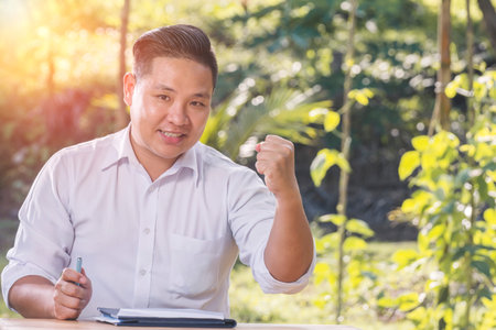 Portrait of an Asian Businessmen being happy with success.の写真素材