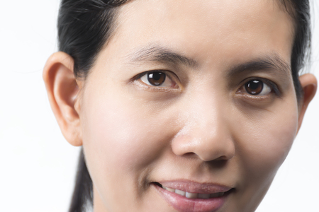 The face of an Asian woman is bright and happy smile on white background.の写真素材