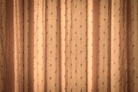 Yellow curtain with sun light. It is a beautiful gold background.の写真素材