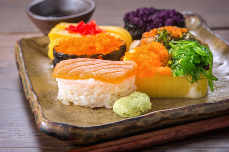 Sushi is one of the most popular Japanese dishes. Placed on plates and containers in Japanese style.の写真素材
