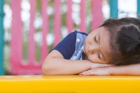 Portraits Cute a little Asian Girl sleeping in the Playground. with Space for Text. After the play until tired.の写真素材