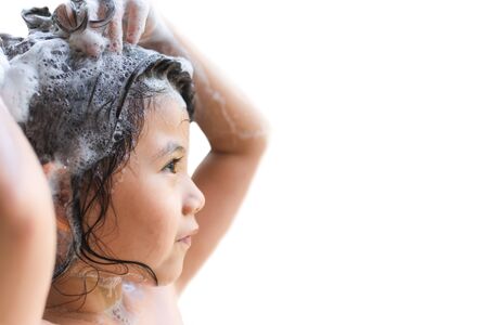 Portrait Cute Little Asian Girl is Washing her Hair.on Isolate White Background with Space for Text.の写真素材