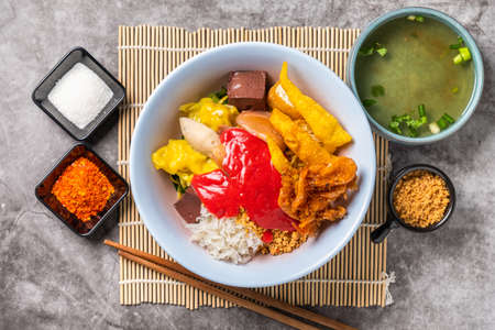 Pink Seafood flat Noodles, ready to Serve on the Dining Table and  Soup is Accompanied by Spicy Seasonings, which is a Favorite Food of Asians. Top Angle View.の写真素材