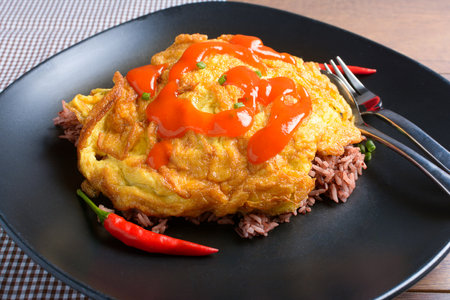 Close-up Thai style pork omelette with Riceberry, Topped Thai chili sauceの写真素材