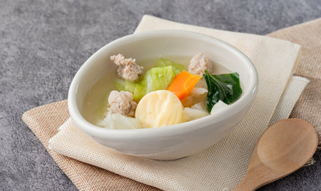Close up Soup with egg tofu and minced pork in a white oval cupの写真素材