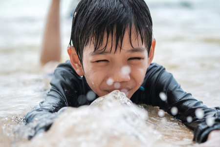 Close-up of Asian thai boys having fun on the beach. concept of fun and learning in natureの写真素材