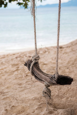 Wooden swing on sand background for tourist advertising, Summer Beach Vacation, Holiday Sea Travel...