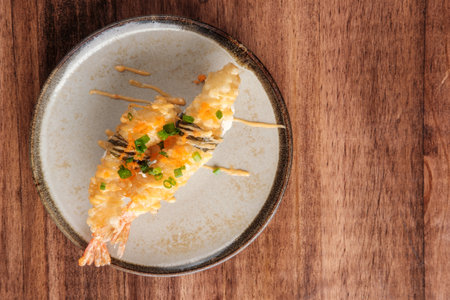 Top View of Shrimp Tempura, Drizzled with Sauce and Topped with Fish Roe with copy space for your text.の写真素材