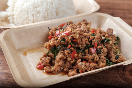 Close-up Stir-fried pork with Holy Basil (Pad Kra Pao Moo), Thai Food Served with Rice, Ready to Eatの写真素材