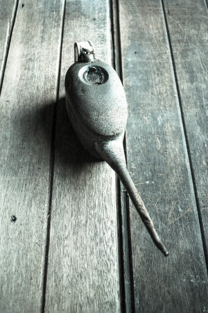 Weathered oil can on the woodenの写真素材