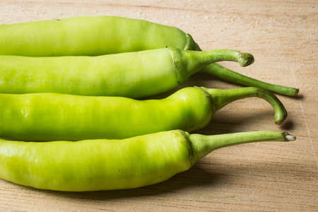 Green peppers on a woodenの写真素材