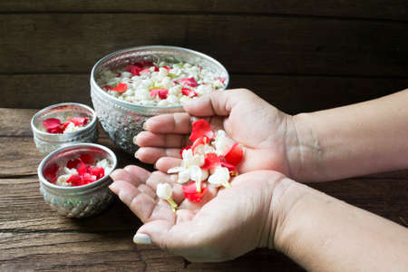 Water in bowl mixed with perfume and flowers corolla for Songkran festival in Thailand.の写真素材