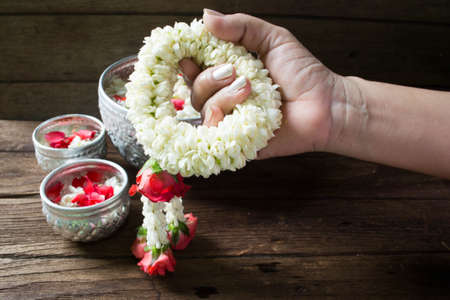 Water in bowl mixed with perfume and flowers corolla for Songkran festival in Thailand.の写真素材