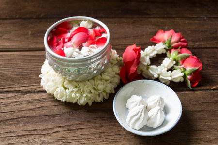 Water in bowl mixed with perfume and flowers corolla for Songkran festival in Thailand.