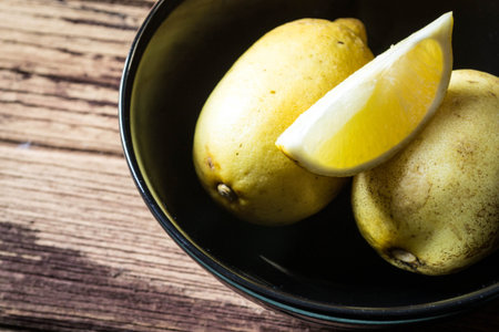 lemons in  black bowlの写真素材