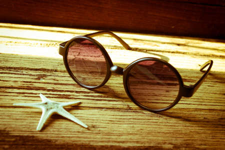 Sunglasses and starfish on wooden, Travel conceptの写真素材