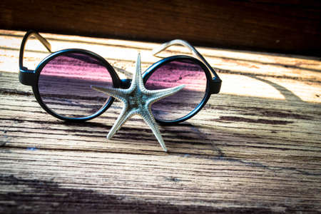 Sunglasses and starfish on wooden, Travel conceptの写真素材