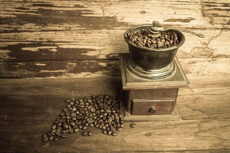 Old coffee grinder and coffee beansの写真素材
