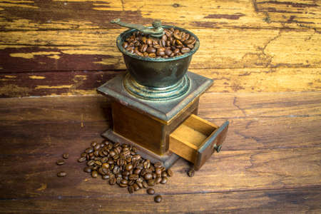 Old coffee grinder and coffee beansの写真素材
