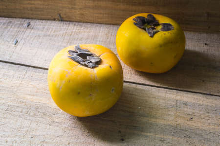 Persimmon on a woodenの写真素材