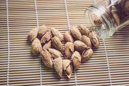 Almonds out of a glass bottleの写真素材