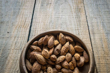 almonds in wooden bowlの写真素材