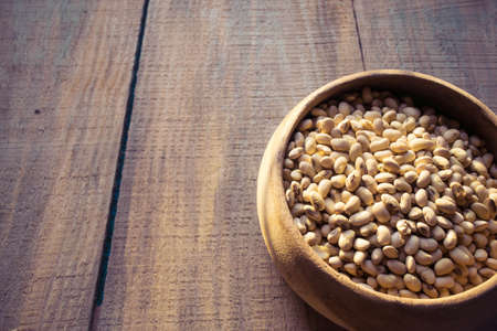 roasted soybeans in wooden bowlの写真素材