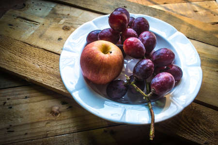 organic purple grapes and appleの写真素材