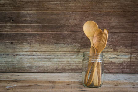 Wooden spoon and fork in a glassの写真素材