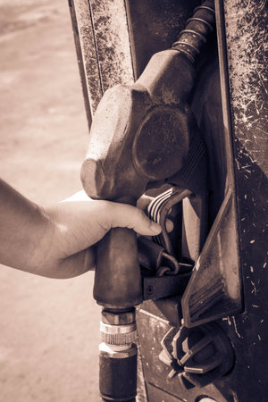 hand holding old fuel nozzleの写真素材