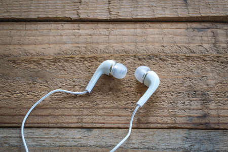 earphones on wooden backgroundの写真素材