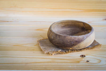 wooden bowl on wooden backgroundの写真素材