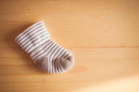 Baby socks  on wooden backgroundの写真素材