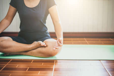 Young woman meditation while practicing yoga  intdoor. Woman exercising vital and meditation for fitness lifestyle  Healthy and Yoga Concept , Calmness and relaxの写真素材