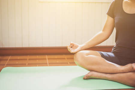 Young woman meditation while practicing yoga  intdoor. Woman exercising vital and meditation for fitness lifestyle  Healthy and Yoga Concept , Calmness and relaxの写真素材