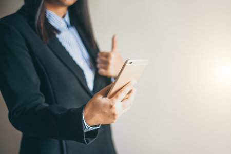 Business woman watching the plans on the smartphoneの写真素材